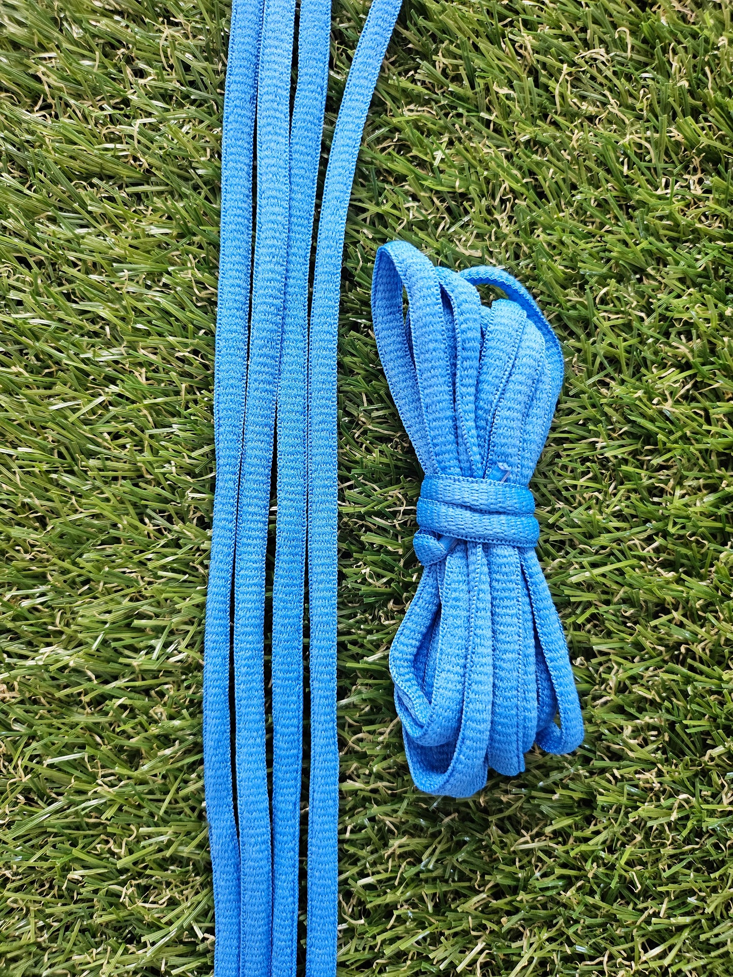 Blue shoelaces on a grass background