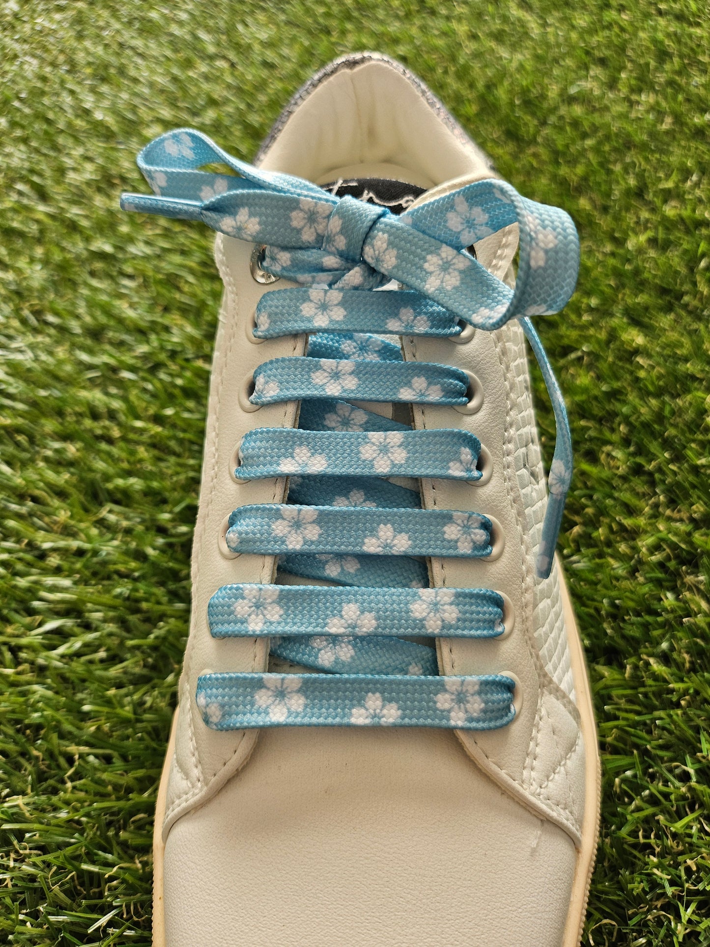 Spring Sky white daisy shoelaces flat lay – floral patterned laces