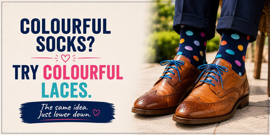 man with multi coloured polka dot socks is wearing brown brogues with bright blue laces