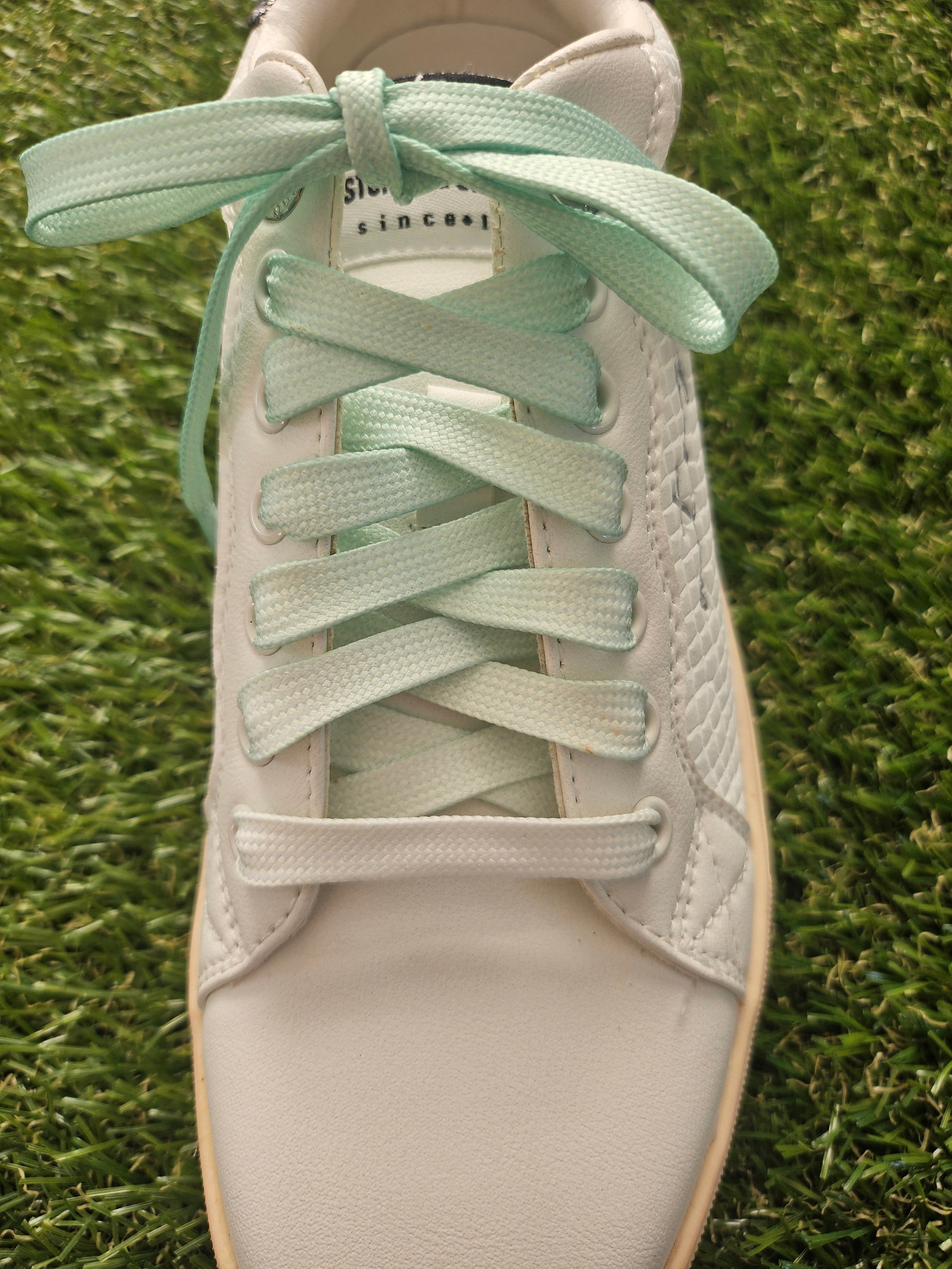 apple green tie dye shoelaces on green grass