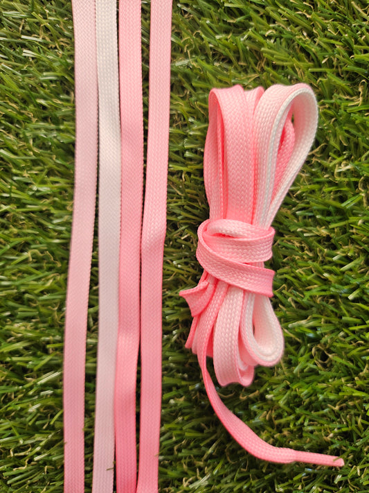 Pink shoelaces on a grass background