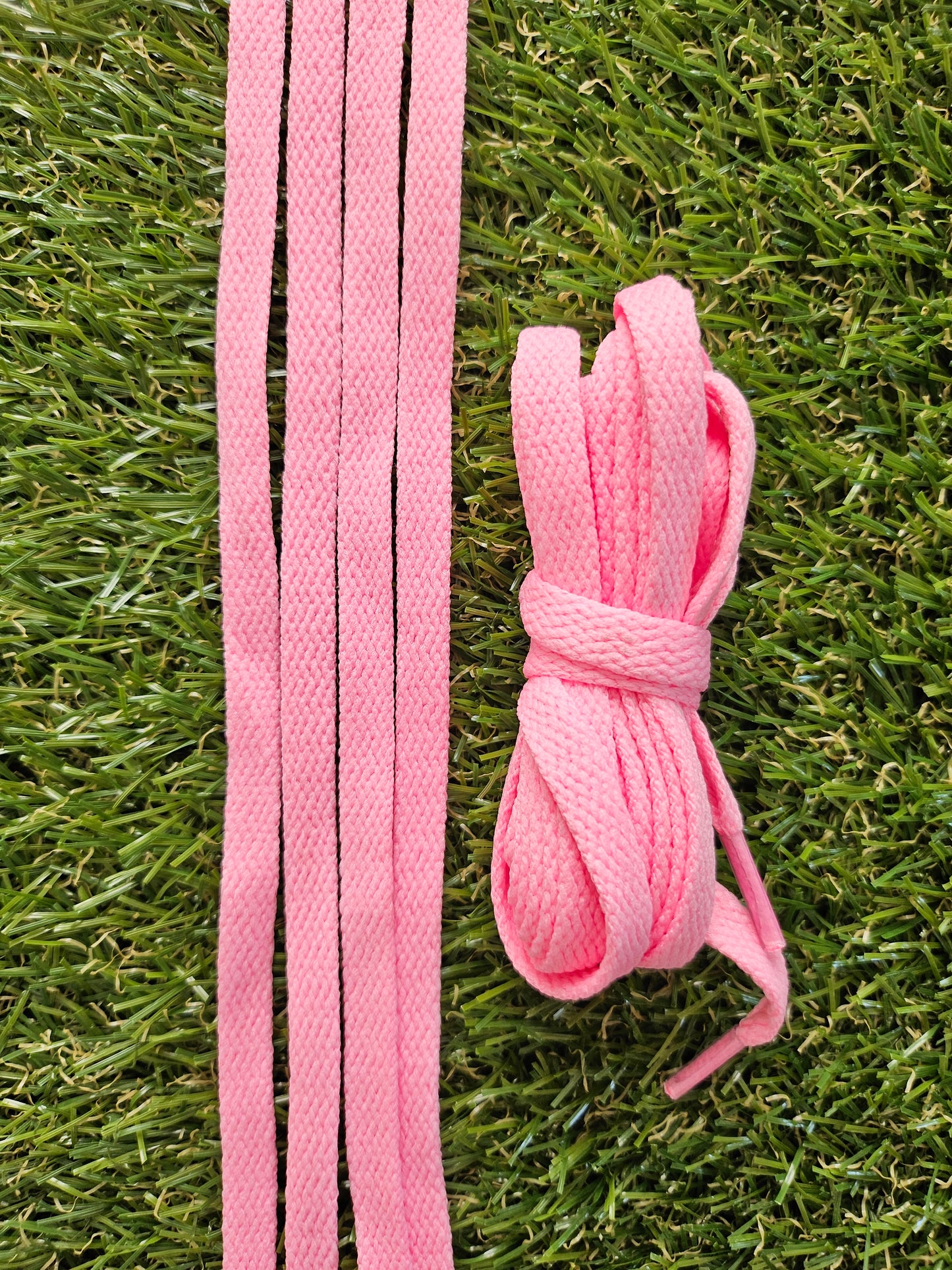 Candy Pink shoelaces on a grass background