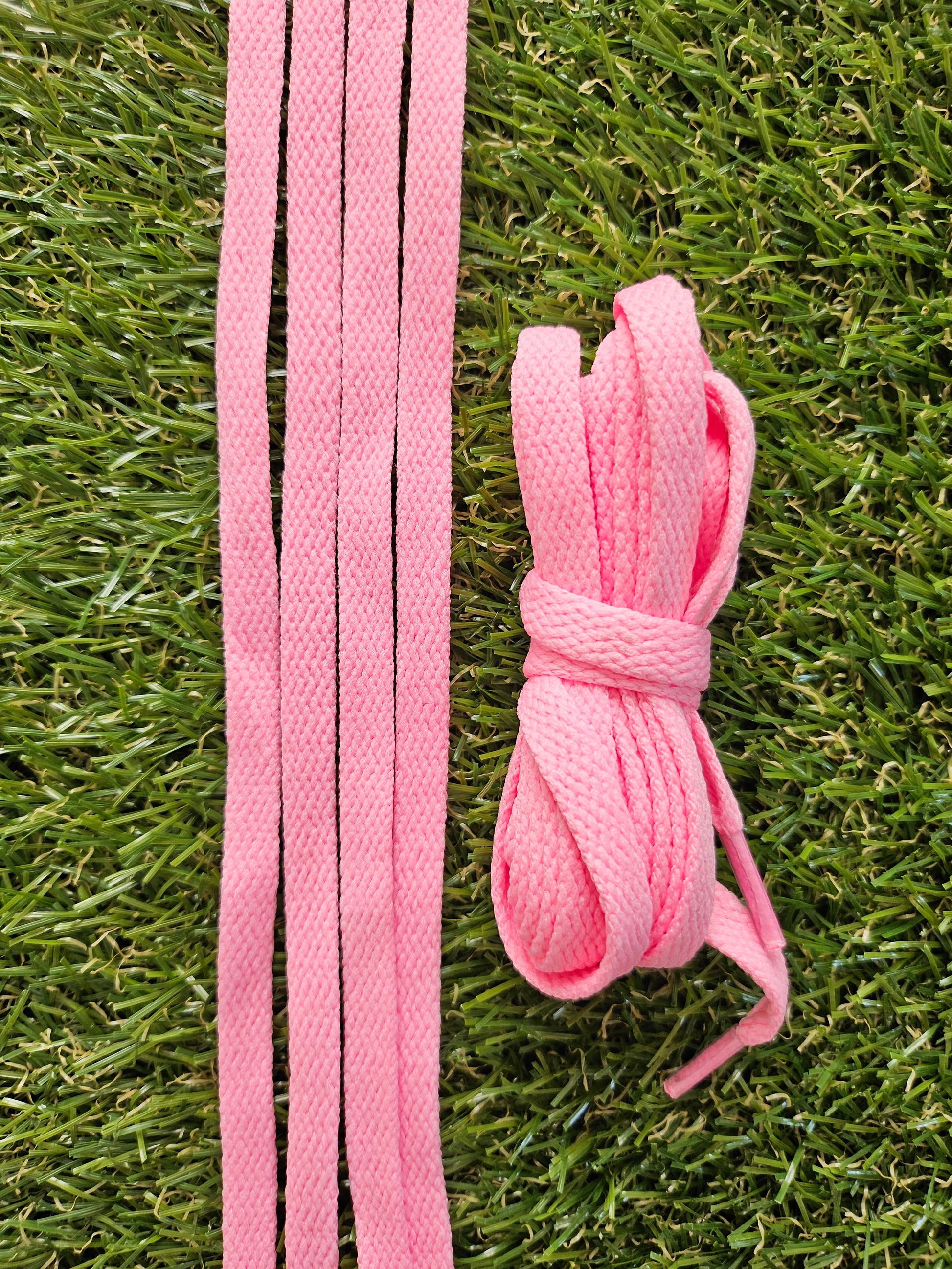 Candy Pink shoelaces on a grass background