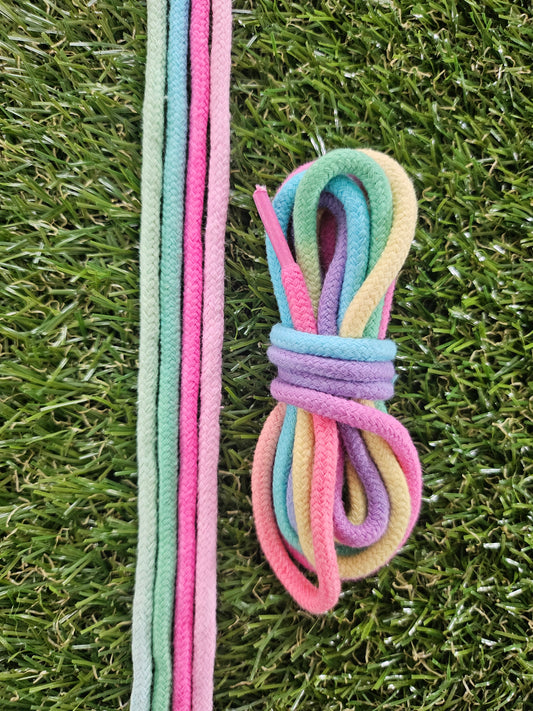 Pastel-colored shoelaces on a grass background