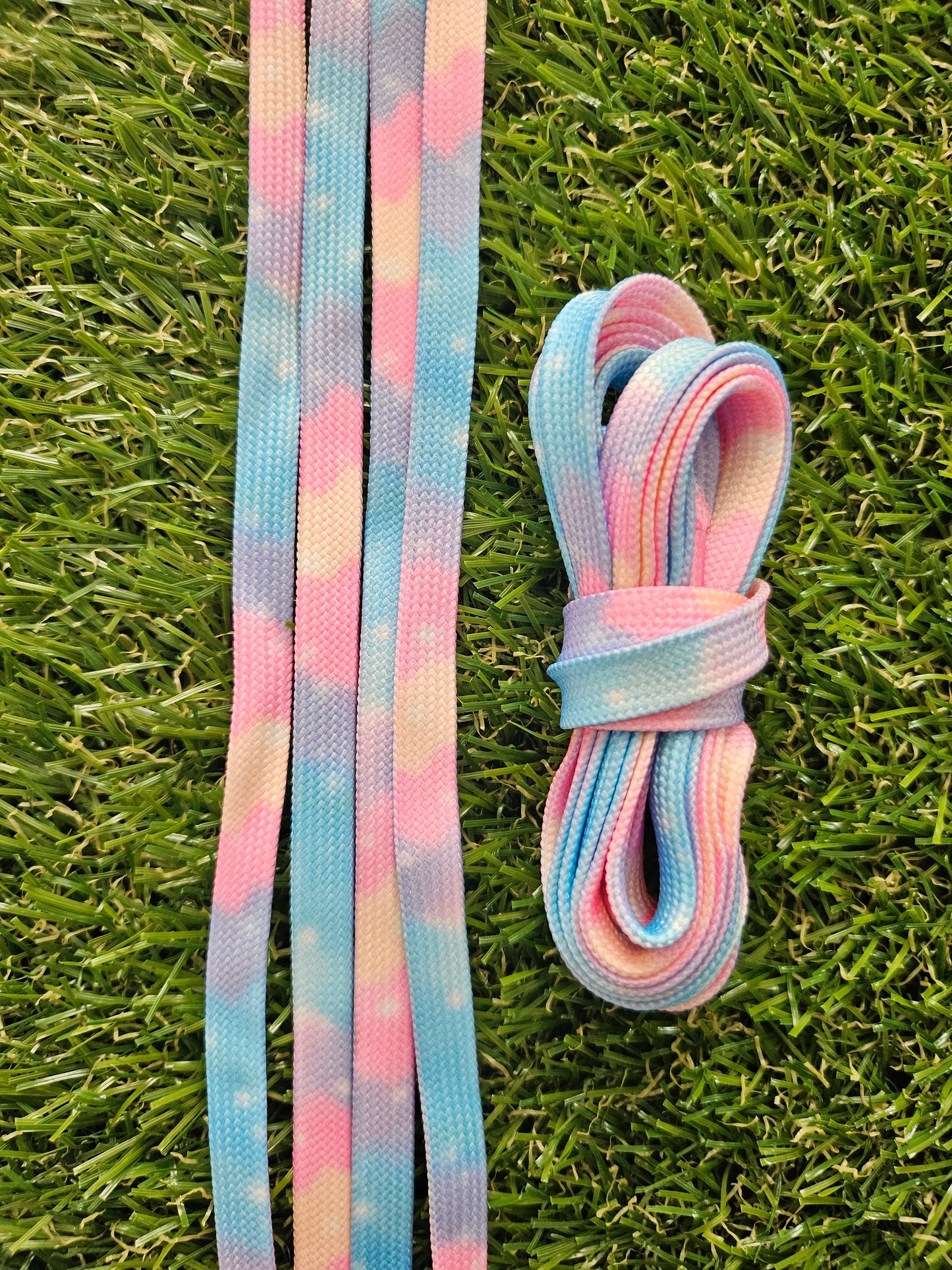 Pastel-colored shoelaces on a grass background