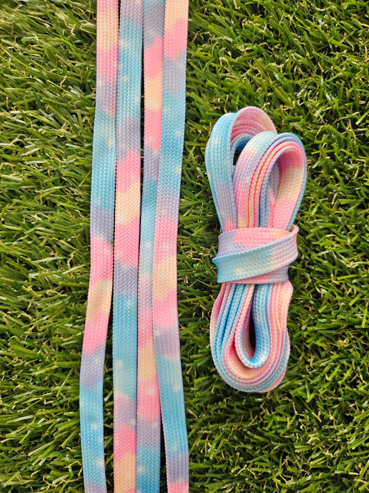 Pastel-colored shoelaces on a grass background