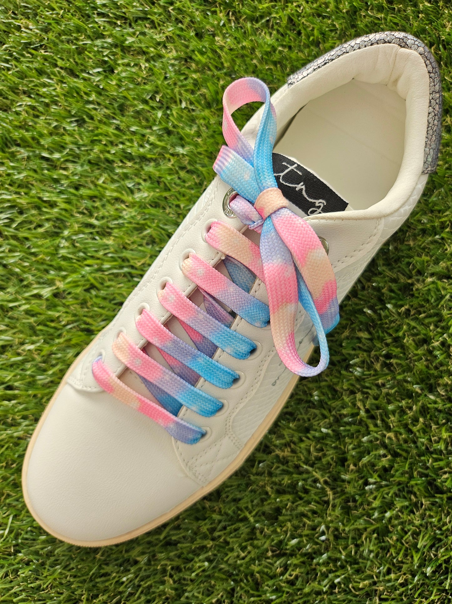 Cloud Candy Fade shoelaces on a grass background