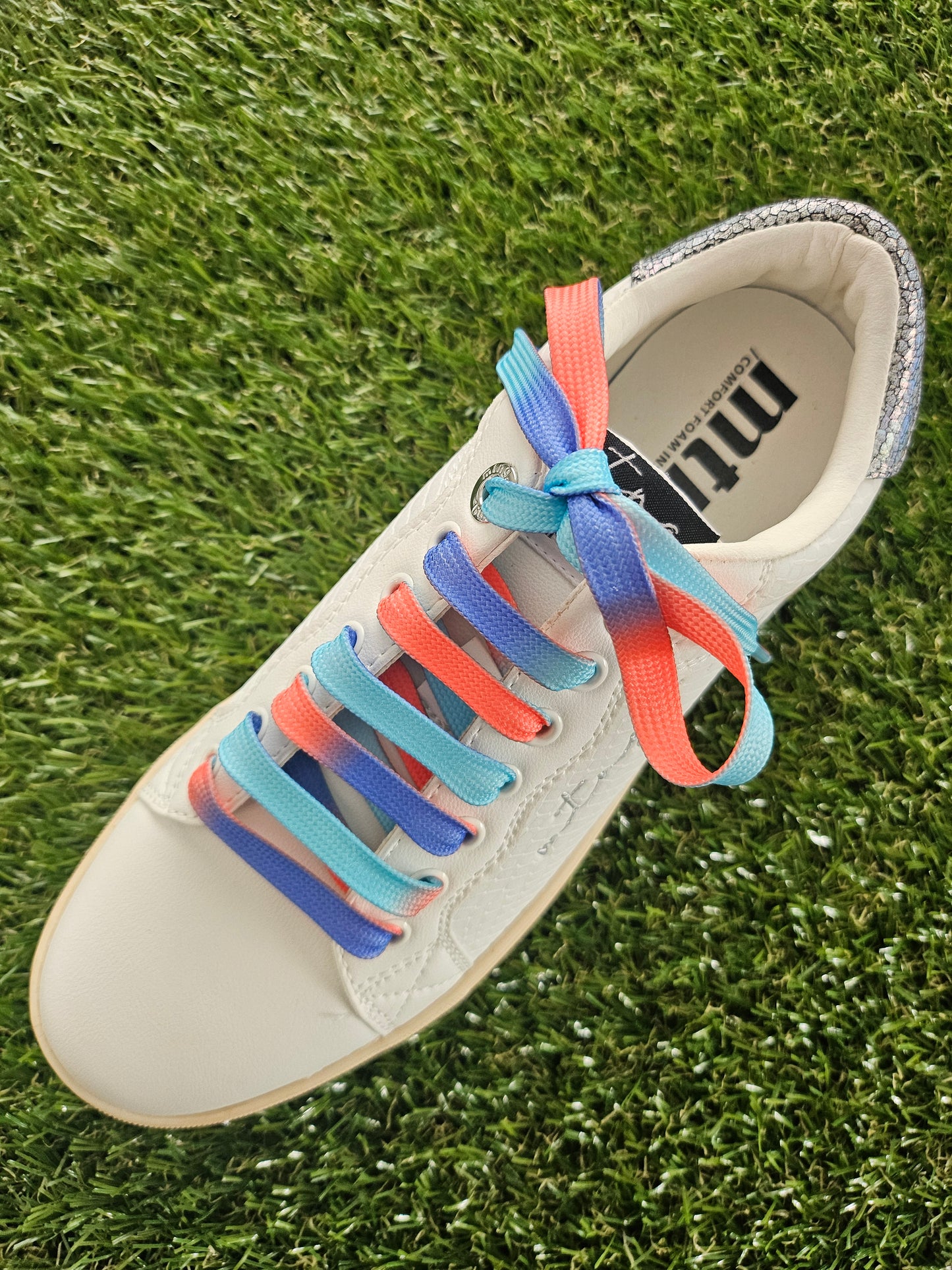ocean sunset coloured shoelaces in a white trainer