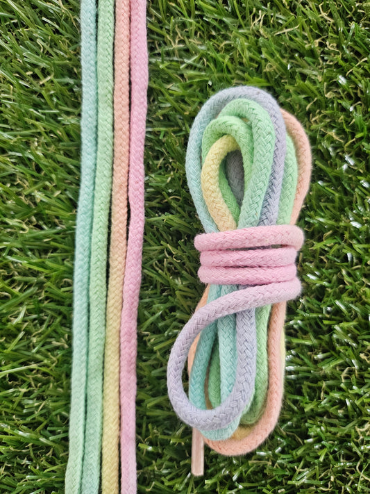 Pastel-colored shoelaces on a grass background