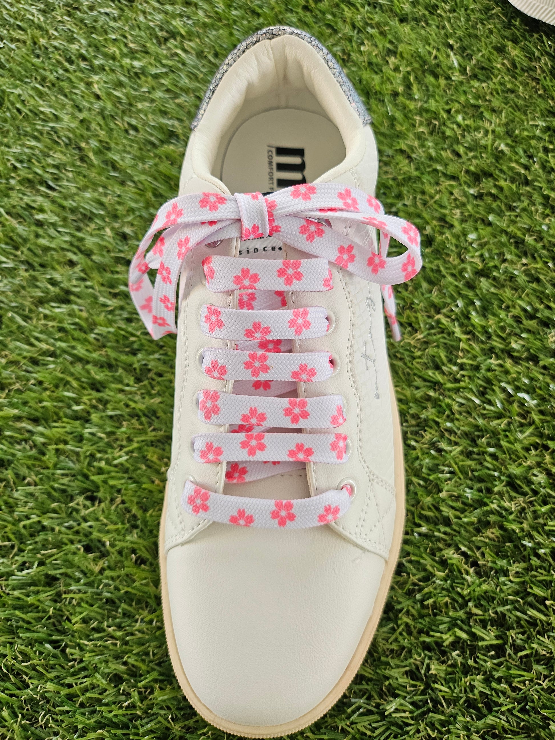 Pink Blossom Laces in white trainers on grass