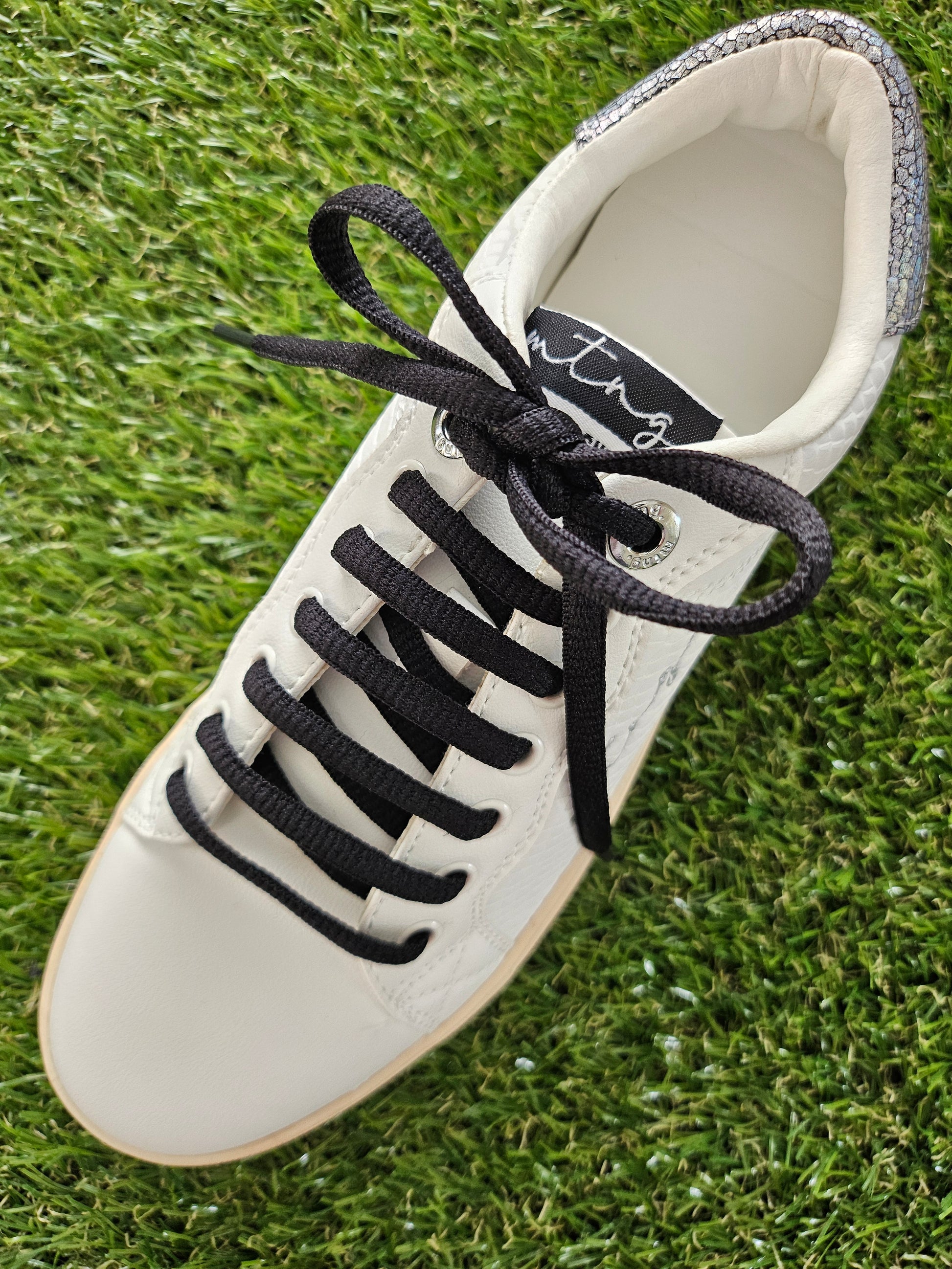 Black laces in white shoe