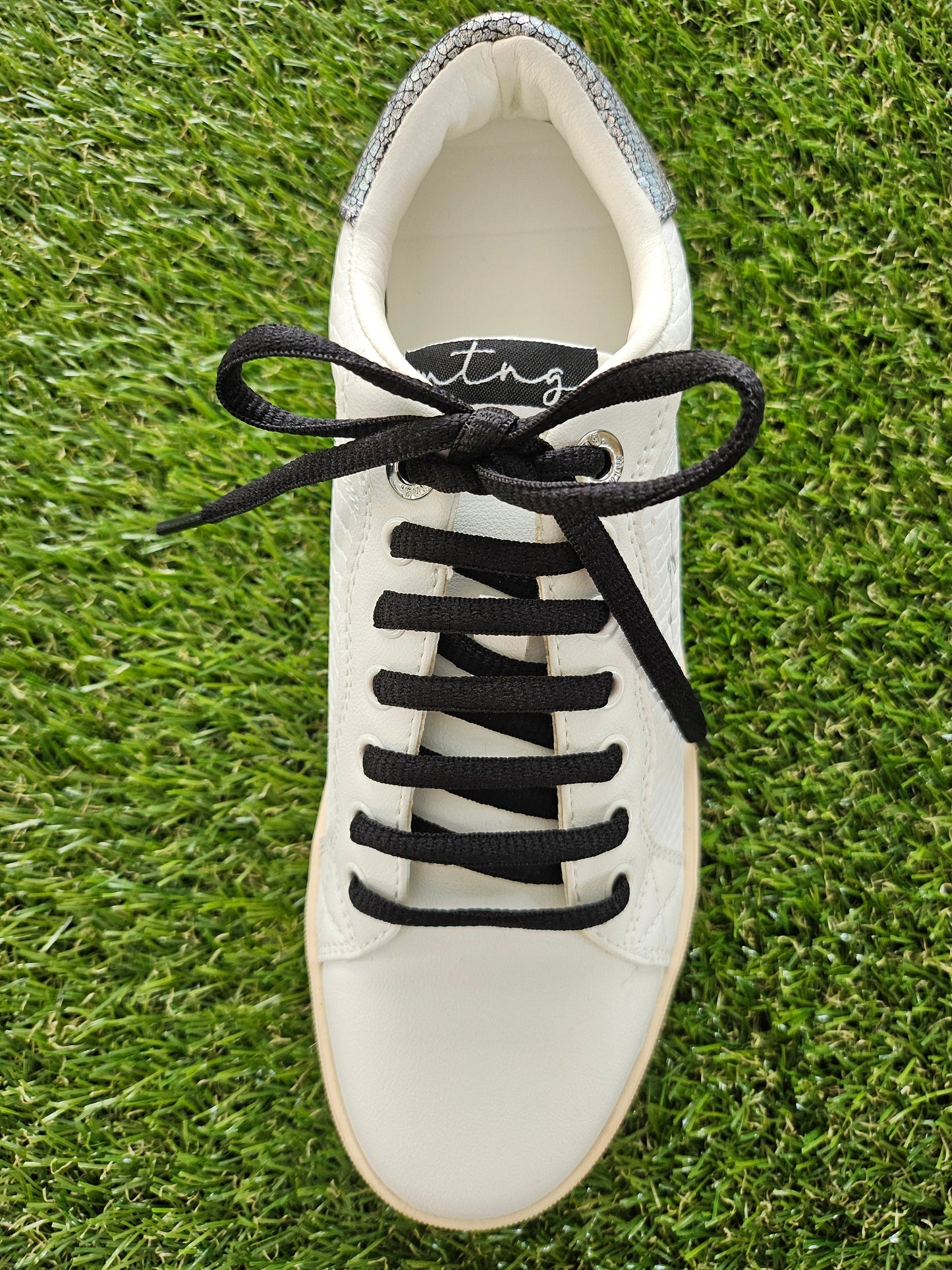 black shoelaces in white shoe