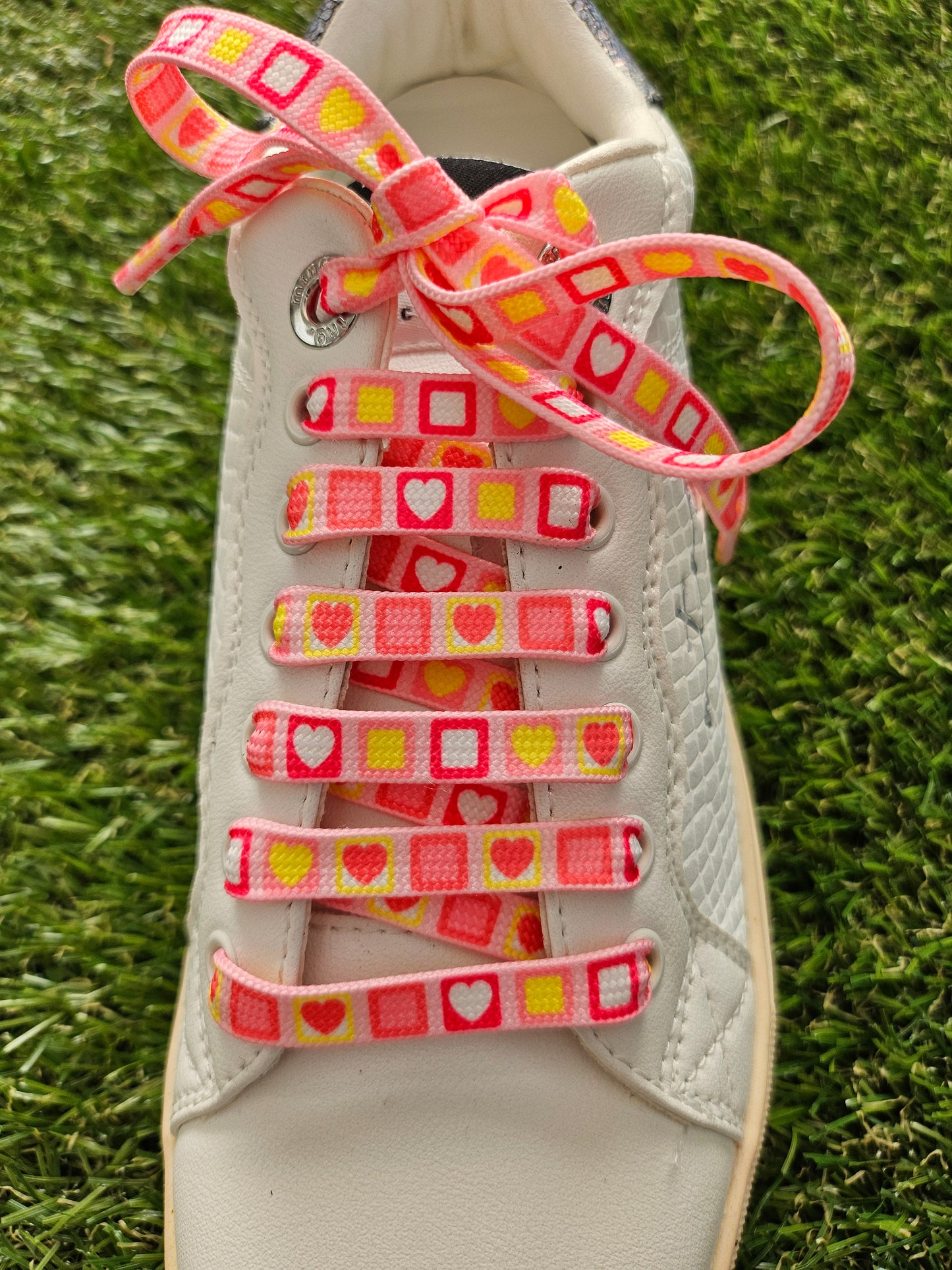 Pretty Pink Heart Candy Square ShoeLaces on green rass