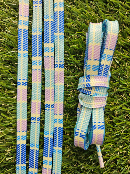 Pastel shoelaces flat lay on grass background