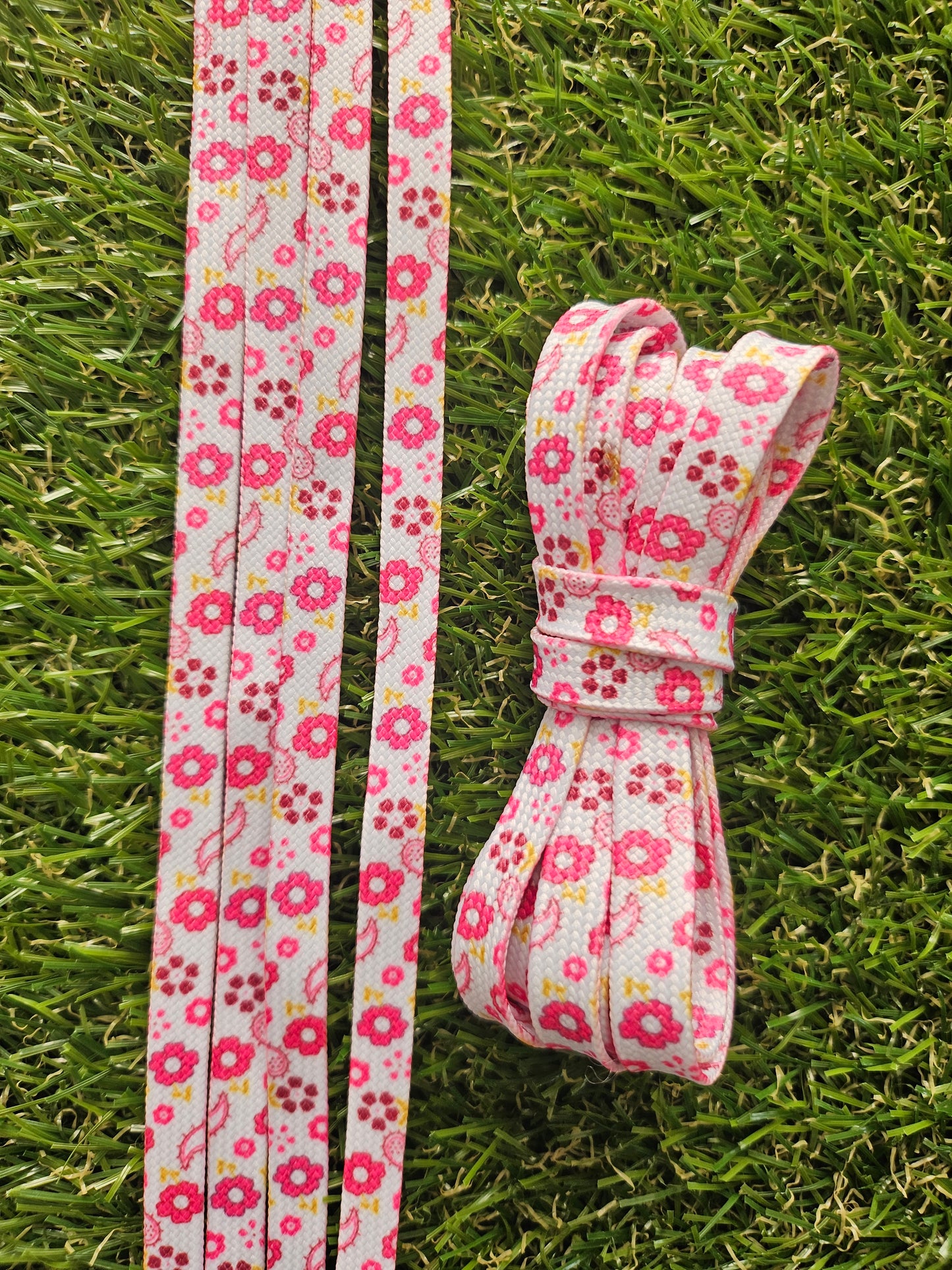 Pink Floral Summer Meadows Shoelaces on green grass