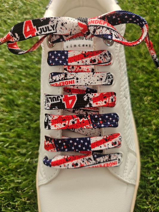 usa flag detailed shoelaces on a white trainer on green grass