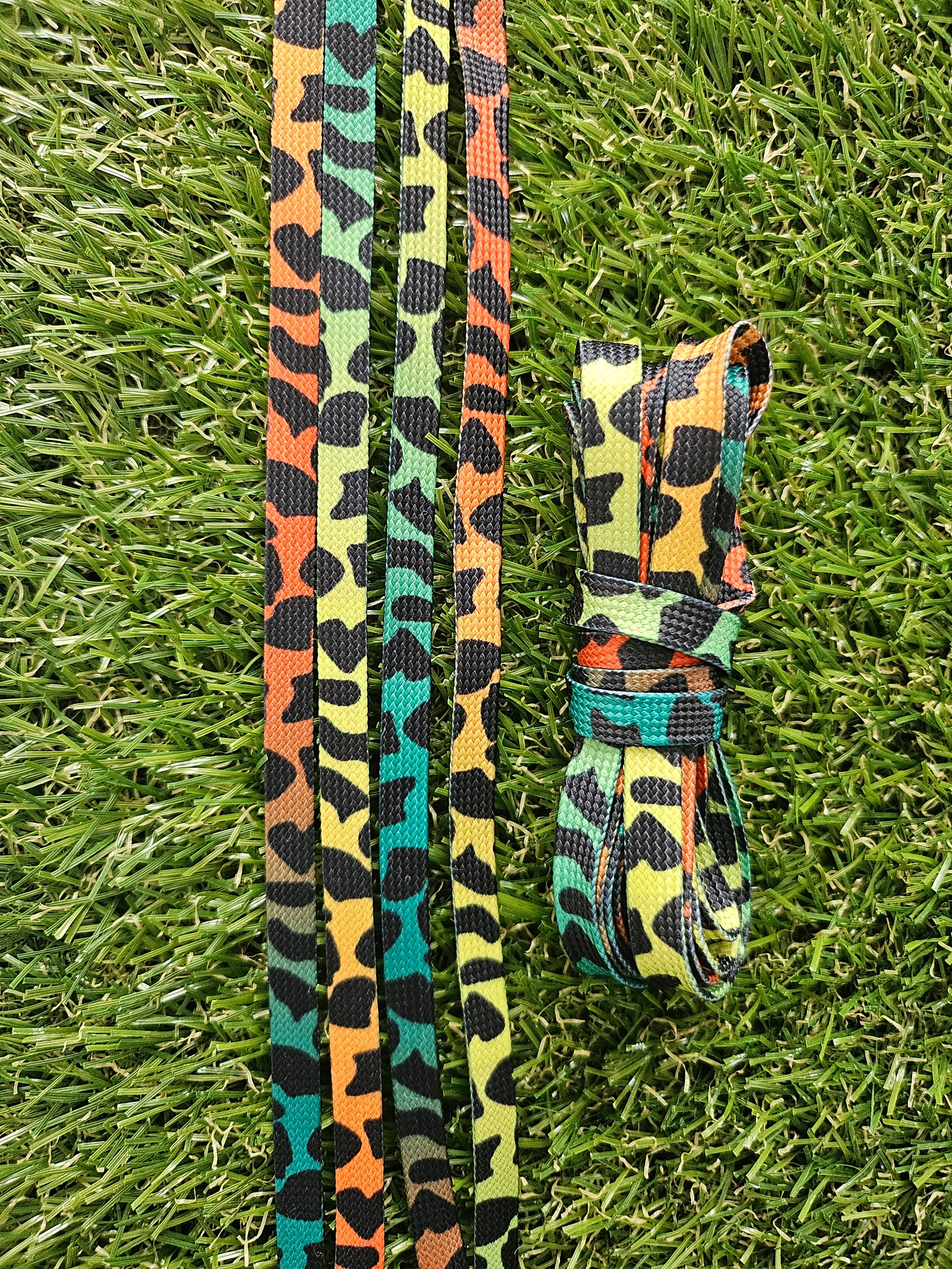 Neon colourful leopard print shoelaces on grass