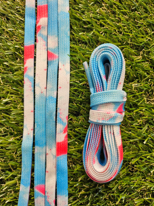 Blue pink and white fusion shoelaces on grass background