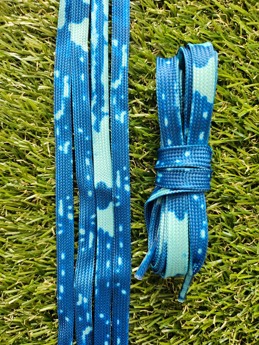 blue and aqua shoelaces on green grass