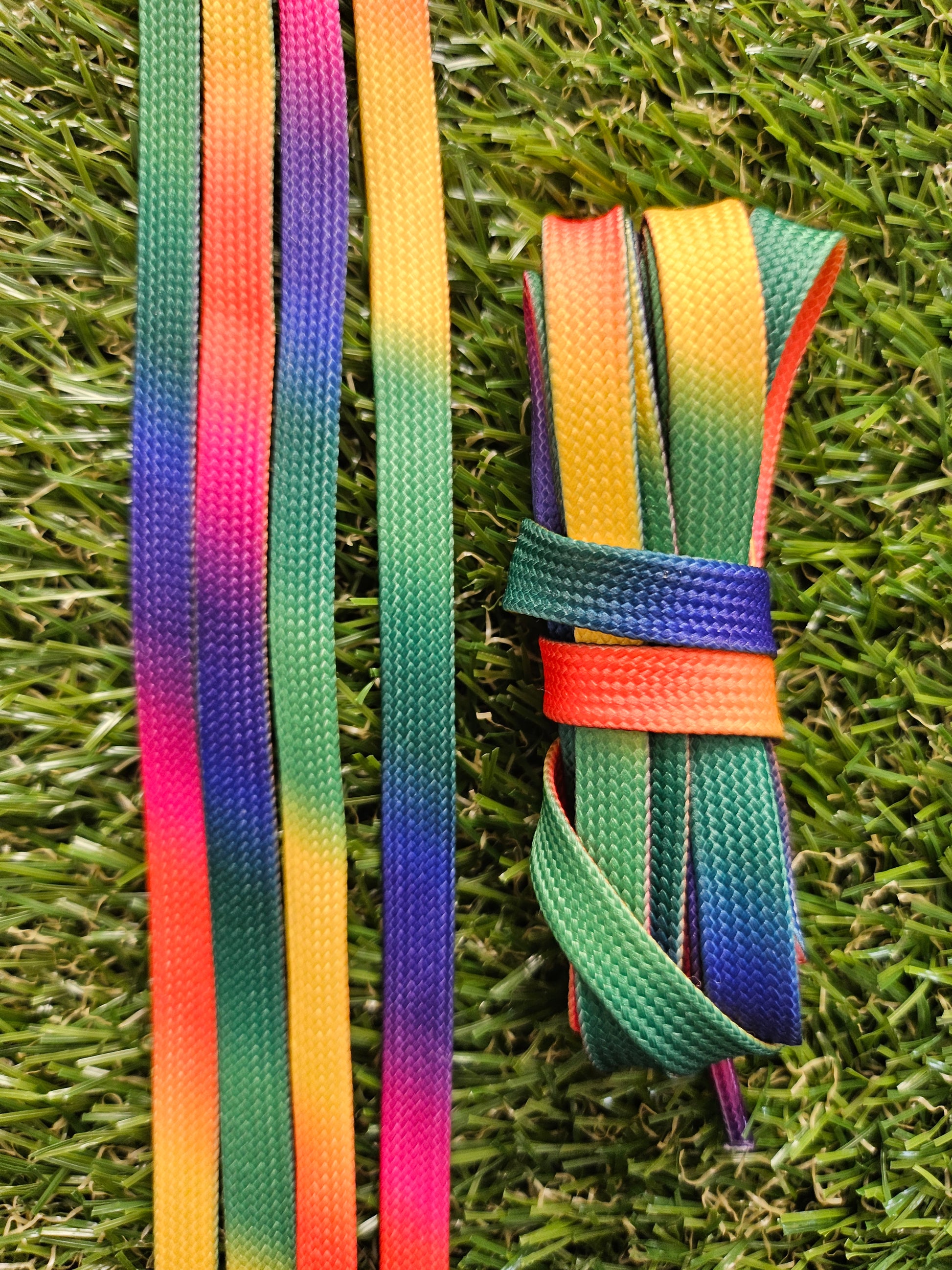 Rainbow shoelaces on green grass