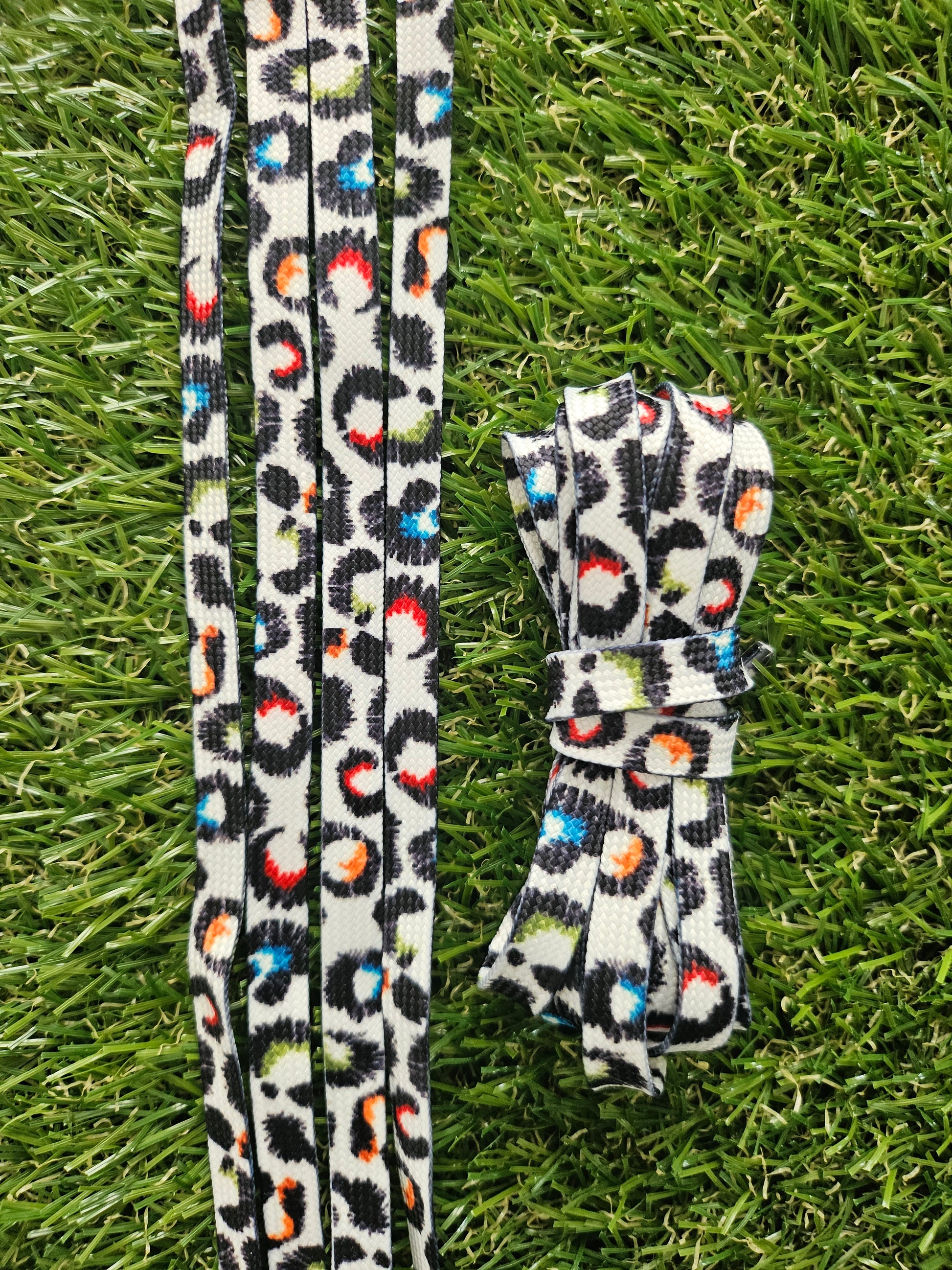 Leopard print shoelaces on a grass background